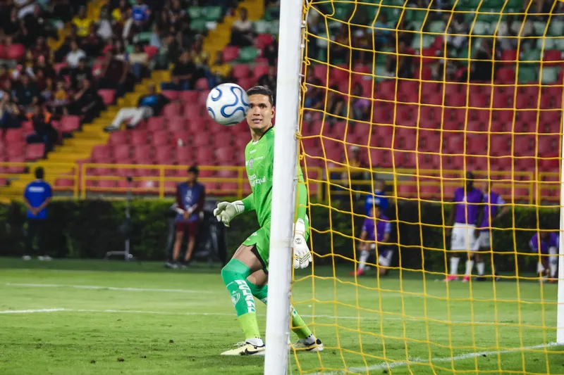 El balón golpea el palo de la portería durante un partido de fútbol.