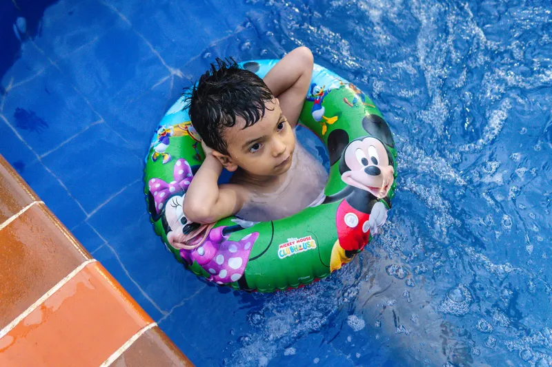 Familia disfrutando de la piscina en casa, en Ibagué.